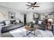 Bright and airy living room with hardwood floors, ceiling fan, and an open layout to the kitchen at 517 Bertram Rd, Fort Mill, SC 29708