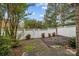 Fenced backyard with garden featuring a stone path, green bushes, and mulch beds at 5216 Berkeley View Cir, Charlotte, NC 28277