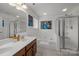 Bright bathroom features double sinks, a soaking tub, and a glass-enclosed shower at 5216 Berkeley View Cir, Charlotte, NC 28277