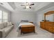 Cozy bedroom features a trey ceiling, neutral walls, and a seating area at 5216 Berkeley View Cir, Charlotte, NC 28277