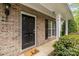 Close up of a brick house's front door and porch with well-kept landscaping at 5216 Berkeley View Cir, Charlotte, NC 28277