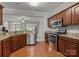 Well-lit kitchen boasting granite countertops, stainless steel appliances, and wood flooring at 5216 Berkeley View Cir, Charlotte, NC 28277