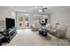 Bright living room with neutral tones, ceiling fan, and french doors to the backyard at 5216 Berkeley View Cir, Charlotte, NC 28277