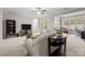 Cozy living room with neutral tones, ceiling fan, and view into sunroom at 5216 Berkeley View Cir, Charlotte, NC 28277