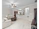 Open-concept living room featuring neutral decor, a ceiling fan, and a view into the kitchen at 5216 Berkeley View Cir, Charlotte, NC 28277