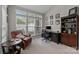 Bright home office featuring a large window, built-in shelves, and comfortable seating area at 5216 Berkeley View Cir, Charlotte, NC 28277