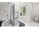 Bright bathroom with a soaking tub and a walk-in shower with white marble at 5416 Woodcreek Dr, Charlotte, NC 28226