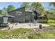 Backyard view of home with stone patio, fireplace, hammock, and screened in porch at 5416 Woodcreek Dr, Charlotte, NC 28226