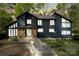 Inviting home exterior with stone accents, a walkway, and exterior lighting at 5416 Woodcreek Dr, Charlotte, NC 28226