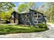 Contemporary home with a striking angular roofline, large windows, and beautiful landscaping at 5416 Woodcreek Dr, Charlotte, NC 28226