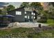 Exterior view of backyard with stone patio, fireplace, and relaxing hammock at 5416 Woodcreek Dr, Charlotte, NC 28226