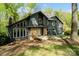 Two-story home with stone accents, a modern design, and well-maintained landscaping at 5416 Woodcreek Dr, Charlotte, NC 28226