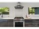 The kitchen boasts stainless appliances, a modern vent hood and large windows at 5416 Woodcreek Dr, Charlotte, NC 28226