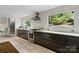 Kitchen with stainless appliances, modern vent hood and cooktop, and large windows at 5416 Woodcreek Dr, Charlotte, NC 28226