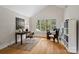 Bright home office featuring large windows, hardwood floors, and comfortable seating at 5416 Woodcreek Dr, Charlotte, NC 28226