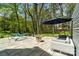 Relax on the backyard stone patio with hammock, fire pit, and lounge seating at 5416 Woodcreek Dr, Charlotte, NC 28226