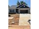 Charming single-story home featuring stone accents, an attached two-car garage, and a well-maintained lawn at 5711 Skinny Down, Charlotte, NC 28215