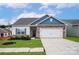 Charming single-Gathering home with stone accents, a two-car garage, and well-maintained landscaping at 5711 Skinny Down, Charlotte, NC 28215