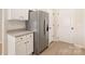 Bright kitchen featuring granite counters, stainless steel refrigerator, and white cabinets at 5711 Skinny Down, Charlotte, NC 28215