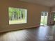 A light-filled living room featuring wood flooring and a view to the outdoors at 5711 Skinny Dr, Charlotte, NC 28215