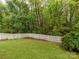 Well-maintained backyard featuring lush green lawn, white picket fence, and mature trees at 6013 Coaching Inn Ct, Charlotte, NC 28270