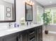 Elegant bathroom with a dual sink vanity, marble countertop, and modern fixtures at 6013 Coaching Inn Ct, Charlotte, NC 28270
