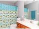 The bathroom featuring a decorative shower curtain, modern fixtures and ample vanity storage at 6013 Coaching Inn Ct, Charlotte, NC 28270