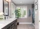 Modern bathroom featuring marble countertop, large window, and stylish grey shower at 6013 Coaching Inn Ct, Charlotte, NC 28270
