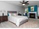 Comfortable bedroom with a fireplace, ceiling fan, and decorative accents for a welcoming retreat at 6013 Coaching Inn Ct, Charlotte, NC 28270