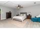 Well-lit bedroom features a ceiling fan, soft rug, and plenty of space at 6013 Coaching Inn Ct, Charlotte, NC 28270