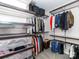 Organized walk-in closet with shelves, rods, and wire baskets for optimal storage solutions at 6013 Coaching Inn Ct, Charlotte, NC 28270