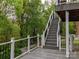 Outdoor deck overlooking a wooded area, complemented by stairs to the yard, and a peaceful retreat at 6013 Coaching Inn Ct, Charlotte, NC 28270