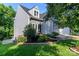 View of the home's siding and manicured front lawn, sidewalk and small privacy fence at 6013 Coaching Inn Ct, Charlotte, NC 28270