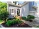 Inviting home entrance featuring a landscaped garden and a classic front door, with sidelight and hanging light at 6013 Coaching Inn Ct, Charlotte, NC 28270