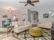 Open-concept living room with hardwood floors, comfortable seating, and an adjacent dining area and kitchen at 6013 Coaching Inn Ct, Charlotte, NC 28270