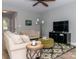 Comfortable living room with neutral walls, hardwood floors, a ceiling fan, and comfortable seating at 6013 Coaching Inn Ct, Charlotte, NC 28270
