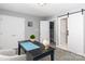 Neutral office space with barn-style sliding door, two closets and neutral carpeting at 6013 Coaching Inn Ct, Charlotte, NC 28270