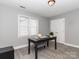 Office space features soft gray walls, natural light, and an abundance of space for productivity at 6013 Coaching Inn Ct, Charlotte, NC 28270