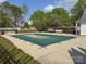 Community pool with secure cover, lounge chairs, and beautiful green landscaping at 6013 Coaching Inn Ct, Charlotte, NC 28270