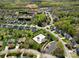 Aerial view of the community pool and recreation area, with surrounding homes and lush landscaping at 7371 Vanguard Ct, Stanley, NC 28164