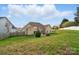 View of the home's backyard, featuring a lush lawn, privacy fence, and attractive landscaping at 7371 Vanguard Ct, Stanley, NC 28164