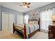 Charming bedroom featuring a decorative ship's wheel, plush carpeting, and ample natural light at 7371 Vanguard Ct, Stanley, NC 28164