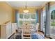 Cozy dining area with a round table, white chairs, and natural light through large windows at 7371 Vanguard Ct, Stanley, NC 28164