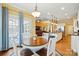 Bright dining area open to kitchen and living space, featuring stylish light fixture and patio access at 7371 Vanguard Ct, Stanley, NC 28164