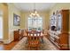 Elegant dining room with hardwood floors, classic chandelier, and traditional wooden furniture at 7371 Vanguard Ct, Stanley, NC 28164