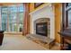 Close-up of a modern fireplace with a decorative mantel and stone accents, next to a window at 7371 Vanguard Ct, Stanley, NC 28164