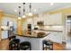 Modern kitchen with a large island, granite countertops, stainless steel appliances, and ample cabinets at 7371 Vanguard Ct, Stanley, NC 28164