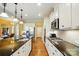 Elegant kitchen featuring granite countertops, stainless steel appliances, and hardwood floors at 7371 Vanguard Ct, Stanley, NC 28164