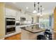 Spacious kitchen with an island, granite countertops, and built-in stainless steel appliances at 7371 Vanguard Ct, Stanley, NC 28164