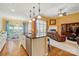 Open concept kitchen with an island, stainless steel appliances, and seamless flow to the living area at 7371 Vanguard Ct, Stanley, NC 28164